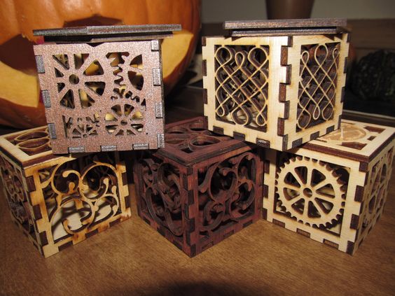A family of 5 two-inch square wooden boxes featuring gears wood white   